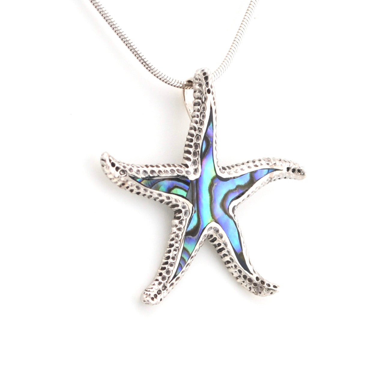 Starfish-shaped pendant with abalone shell inlay on a white background