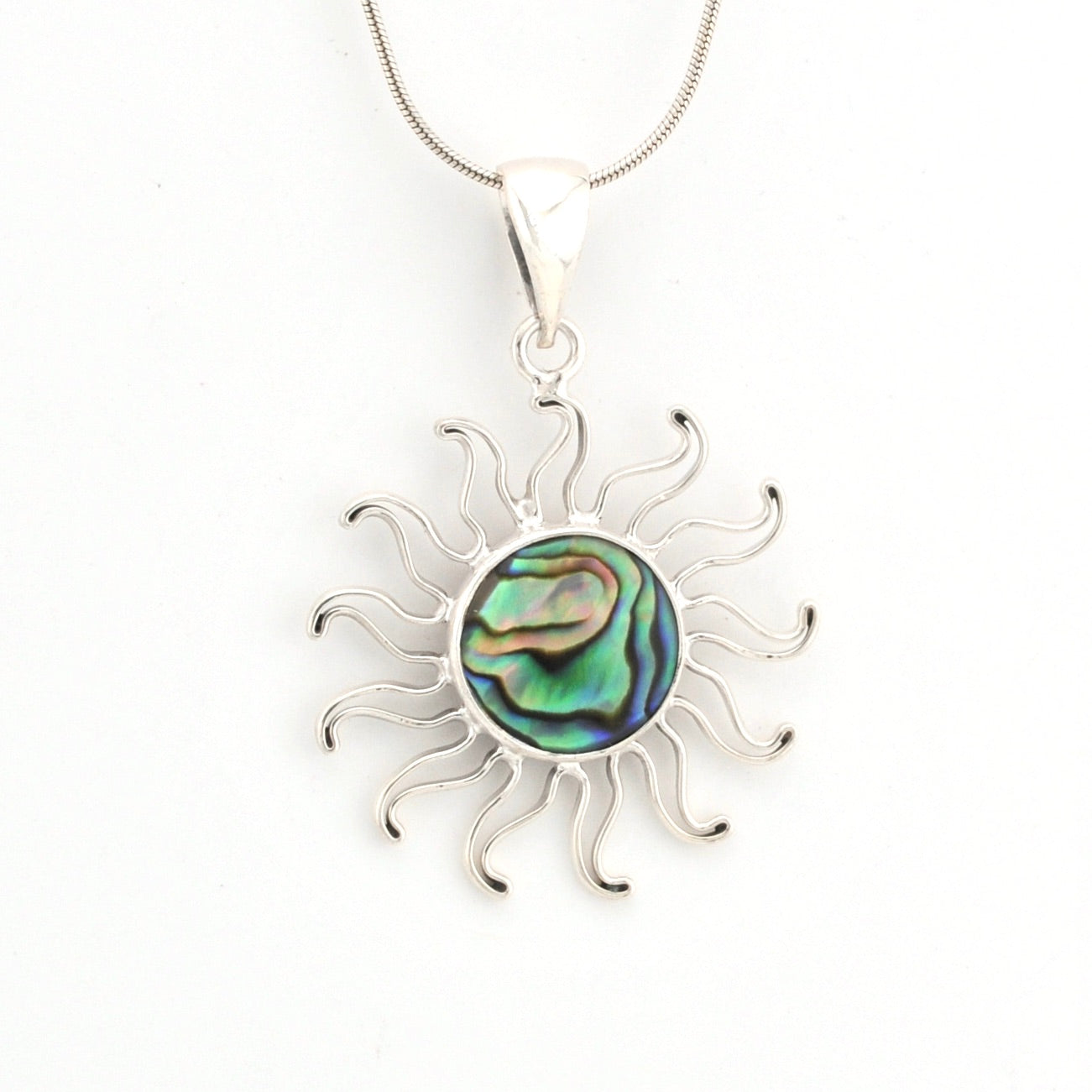 Silver sun-shaped pendant with abalone shell center on a white background