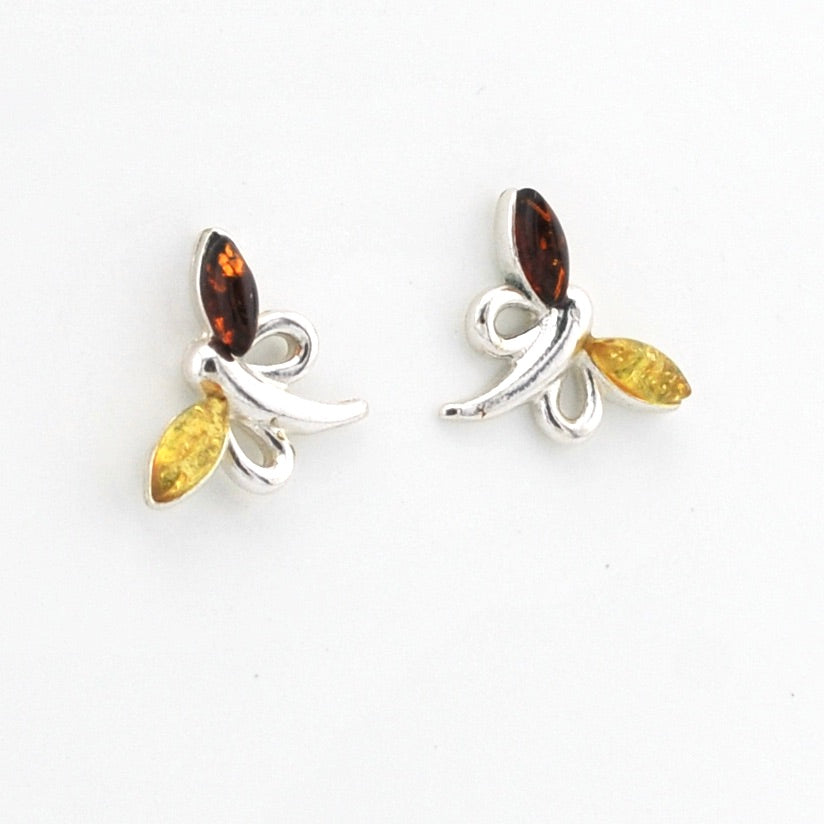 A pair of silver dragonfly stud earrings featuring marquise-cut amber brown wings and yellow-green body accents, displayed on a clean white background.