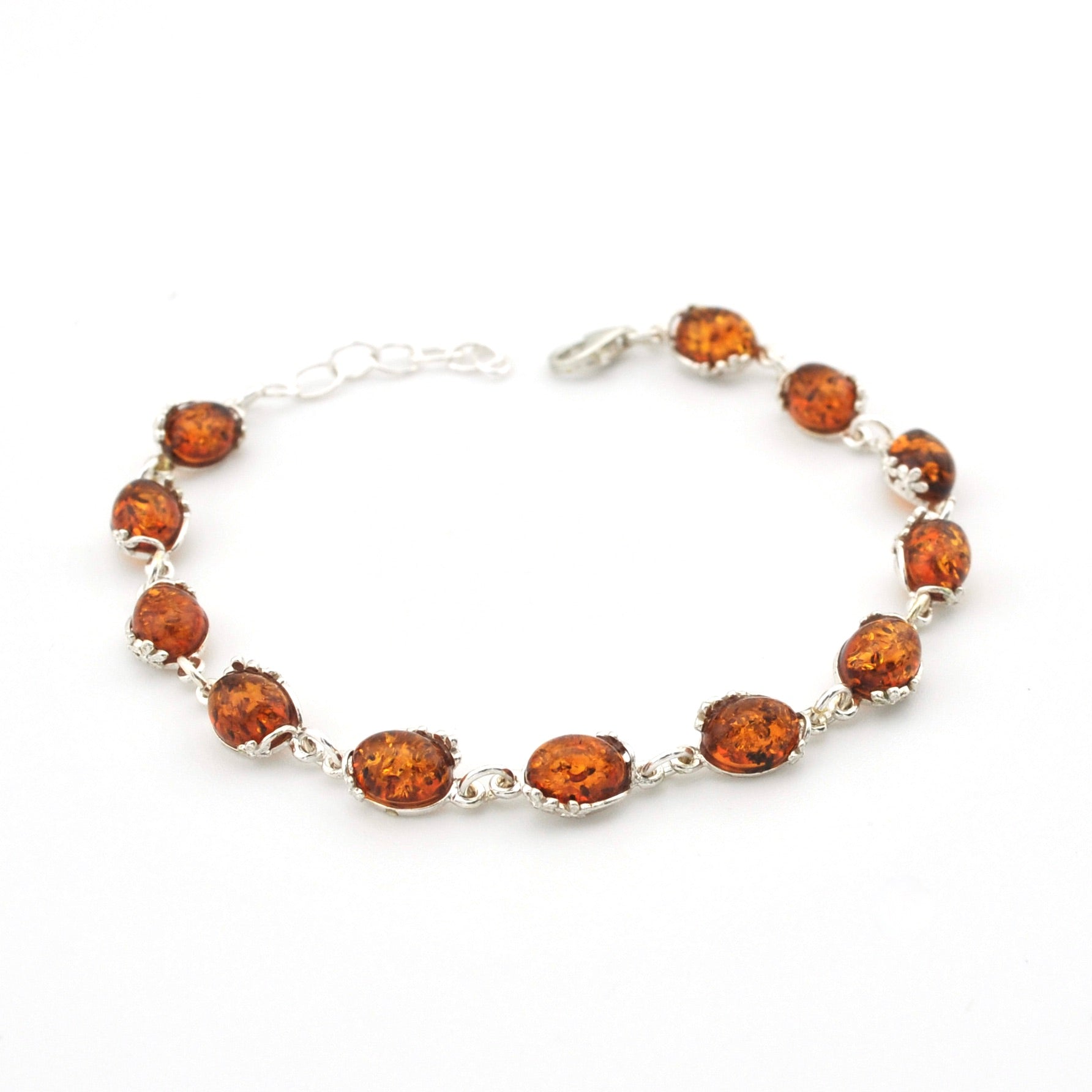 A silver-tone beaded bracelet featuring seven polished oval amber brown gemstones, displayed on a clean white background.