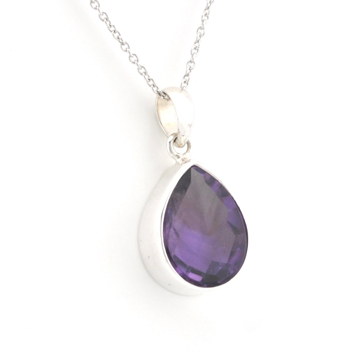 A silver teardrop pendant necklace featuring a faceted purple amethyst gemstone, shown on a clean white background.