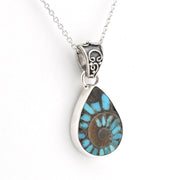 A silver teardrop pendant necklace featuring a natural turquoise and brown ammolite fossil inlay, suspended from a delicate silver chain against a white background.