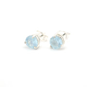 Pair of silver earrings with blue gemstones on a white background