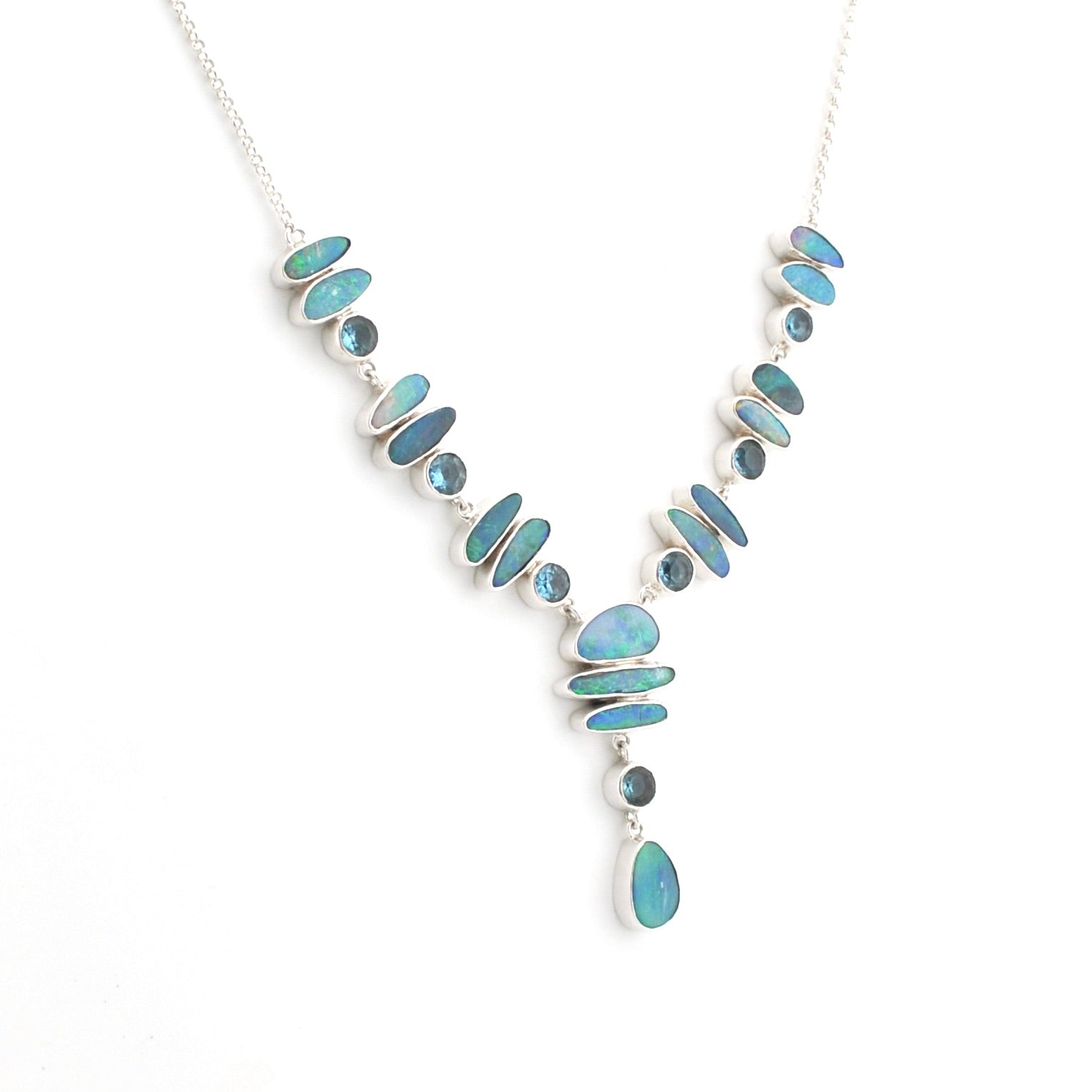 A silver Y-shaped necklace featuring multiple iridescent blue-green stones in oval and teardrop shapes, displayed on a clean white background.