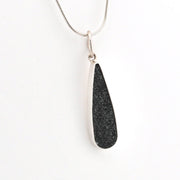 Necklace with a black pendant on a white background