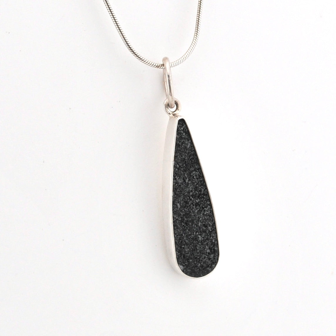 Necklace with a black pendant on a white background