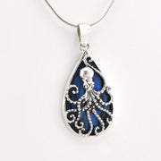 Tear shaped pendant with an octopus design and blue abalone on silver snake chain.
