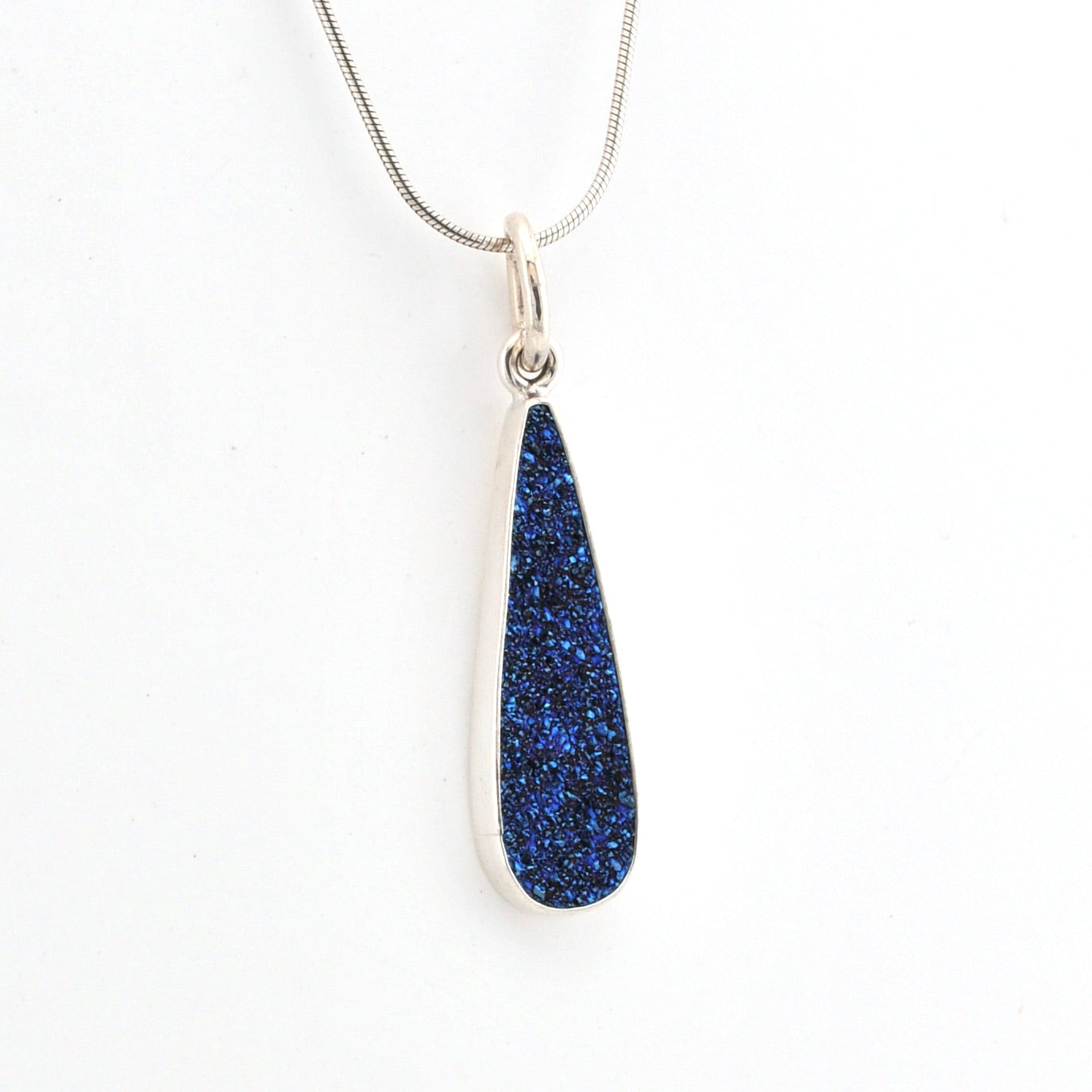 Blue teardrop pendant on a silver chain against a white background