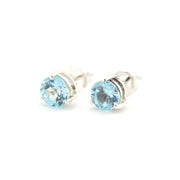 Pair of silver stud earrings with blue gemstones on a white background