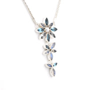A silver-toned floral dangle necklace featuring light blue marquise-cut stones and a central white pearl, shown against a plain white background.