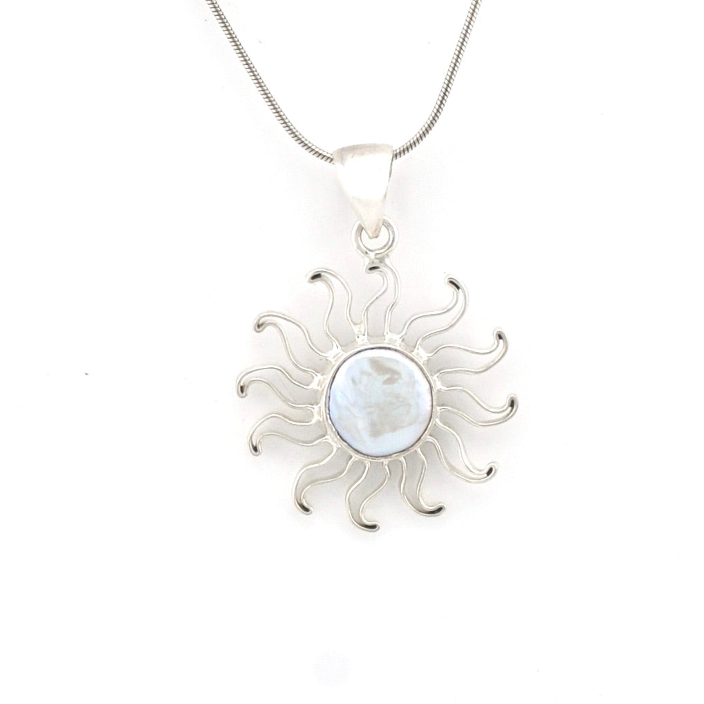Silver sun-shaped pendant with a central circular gemstone on a white background