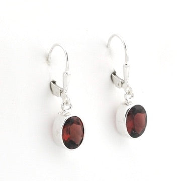 A pair of silver leverback earrings with oval dark brown gemstones, shown against a plain white background.