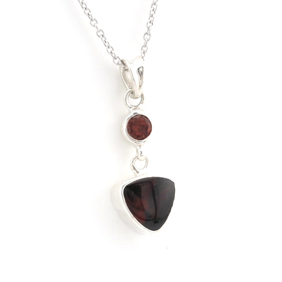 Garnet pendant on a silver chain  on a white background