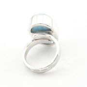 A silver ring light blue stone, photographed on a seamless white background.