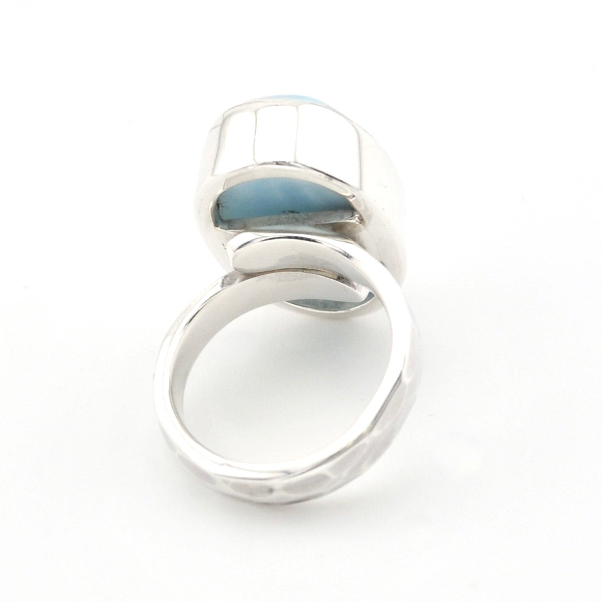 A silver ring light blue stone, photographed on a seamless white background.