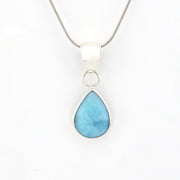 Teardrop-shaped blue pendant on a silver chain against a white background