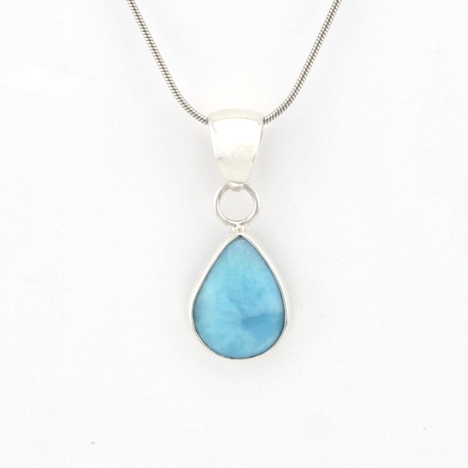 Teardrop-shaped blue pendant on a silver chain against a white background