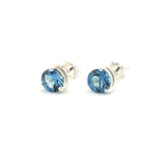 Blue topaz post earrings on a white background