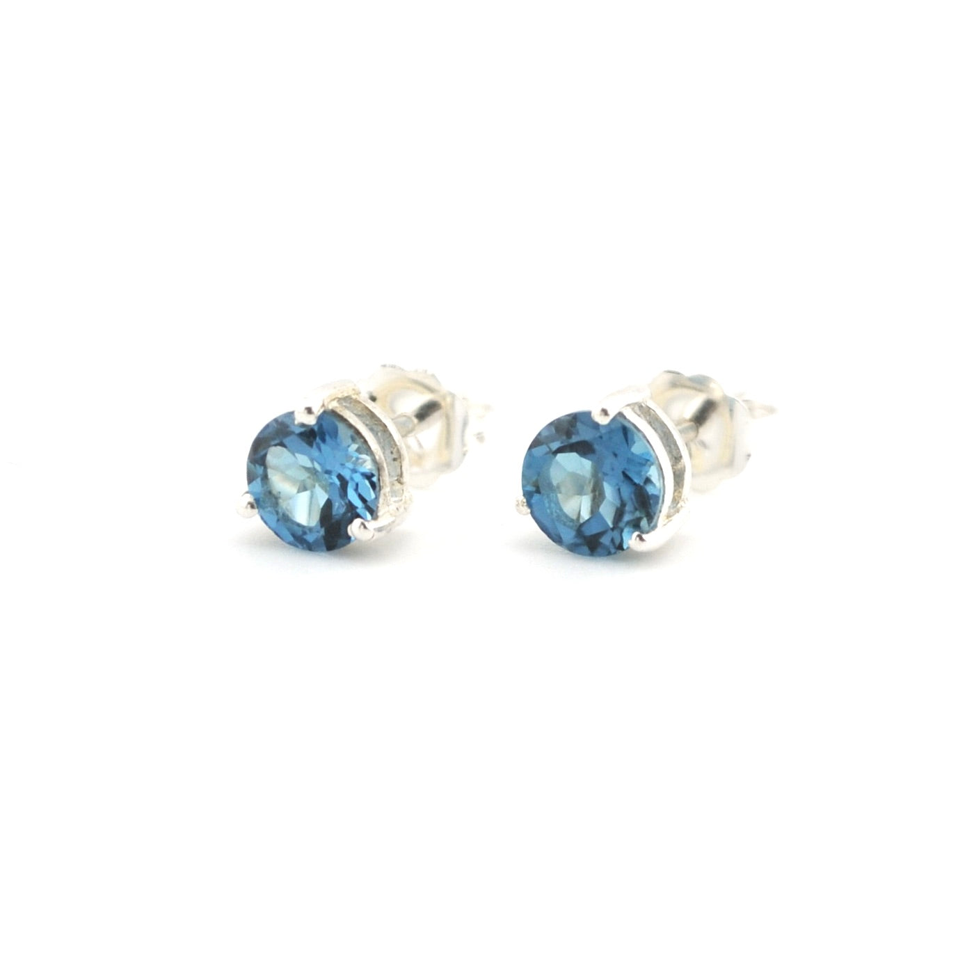 Blue topaz post earrings on a white background