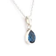 Necklace with a pendant featuring three colorful gemstones on a white background