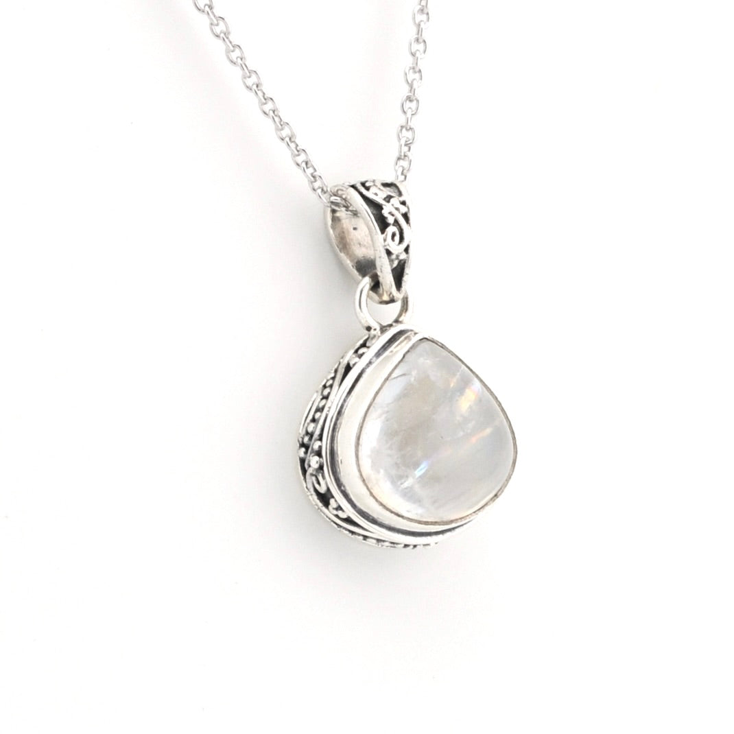 A silver pendant necklace featuring a teardrop-shaped iridescent white gemstone in a detailed silver bezel setting, suspended from a delicate silver chain against a plain white background.