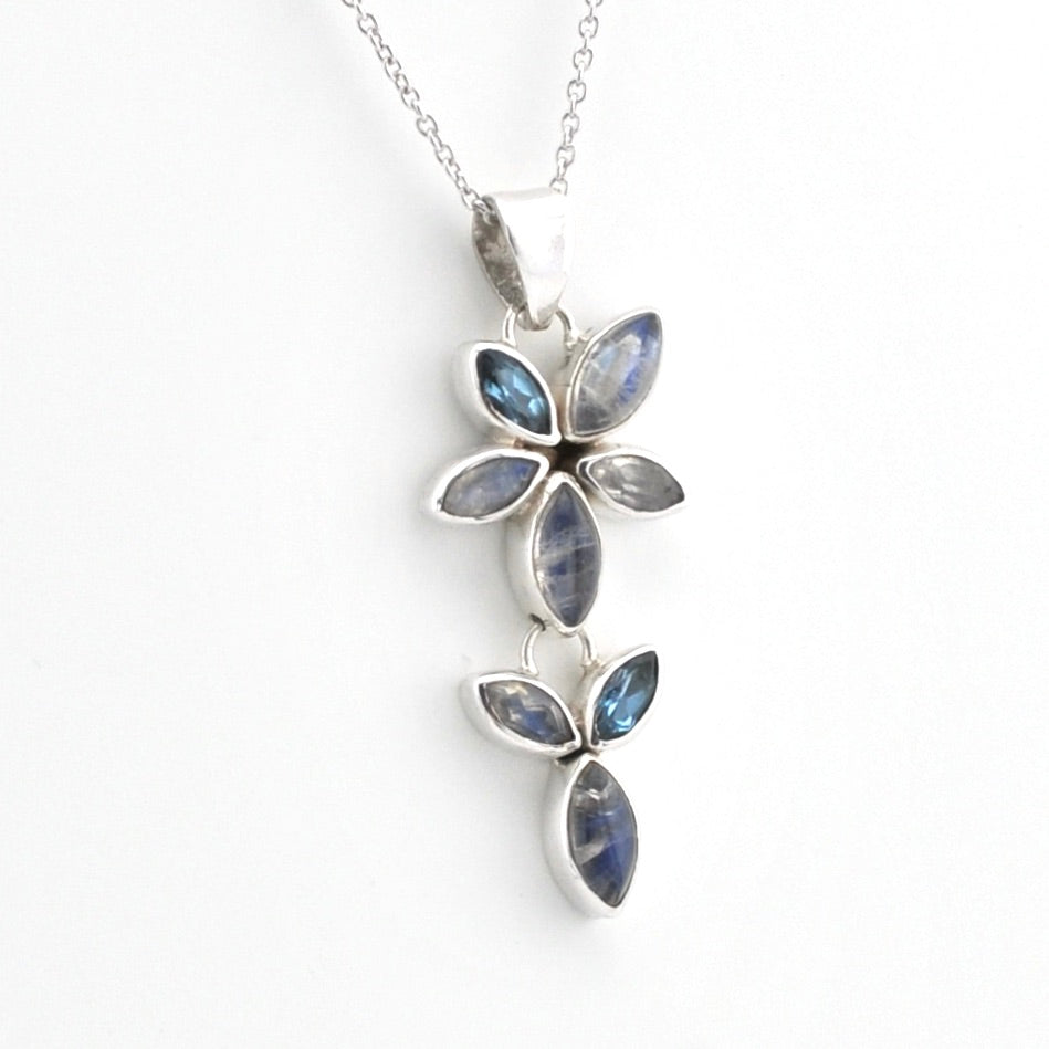 A silver pendant necklace featuring three vertical clusters of marquise-cut blue iridescent gemstones in silver settings, suspended from a delicate silver chain against a plain white background.