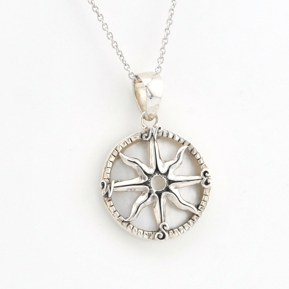 A silver compass rose pendant necklace on a delicate silver chain, displayed against a clean white background.