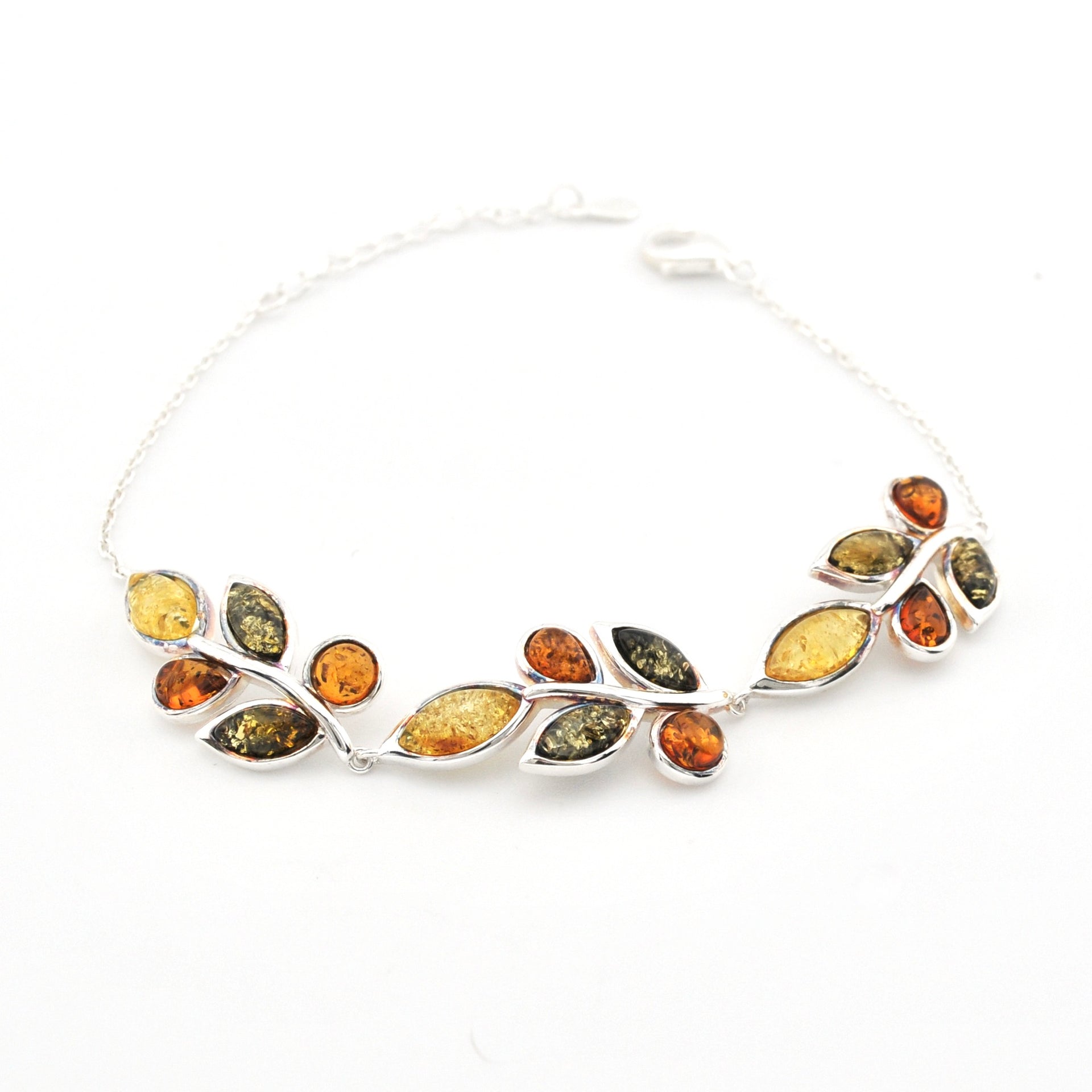 A silver leaf-shaped bracelet featuring multiple small amber stones in yellow, orange, and olive green hues, displayed on a clean white background.