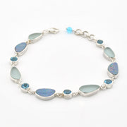 A silver link bracelet featuring large teardrop-shaped light blue-green opal stones and smaller round blue gemstone accents, displayed on a clean white background.