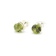 Pair of green gemstone stud earrings on a white background