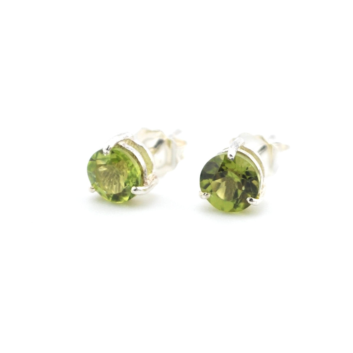 Pair of green gemstone stud earrings on a white background
