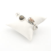 Silver bracelet with shell charms on a white background