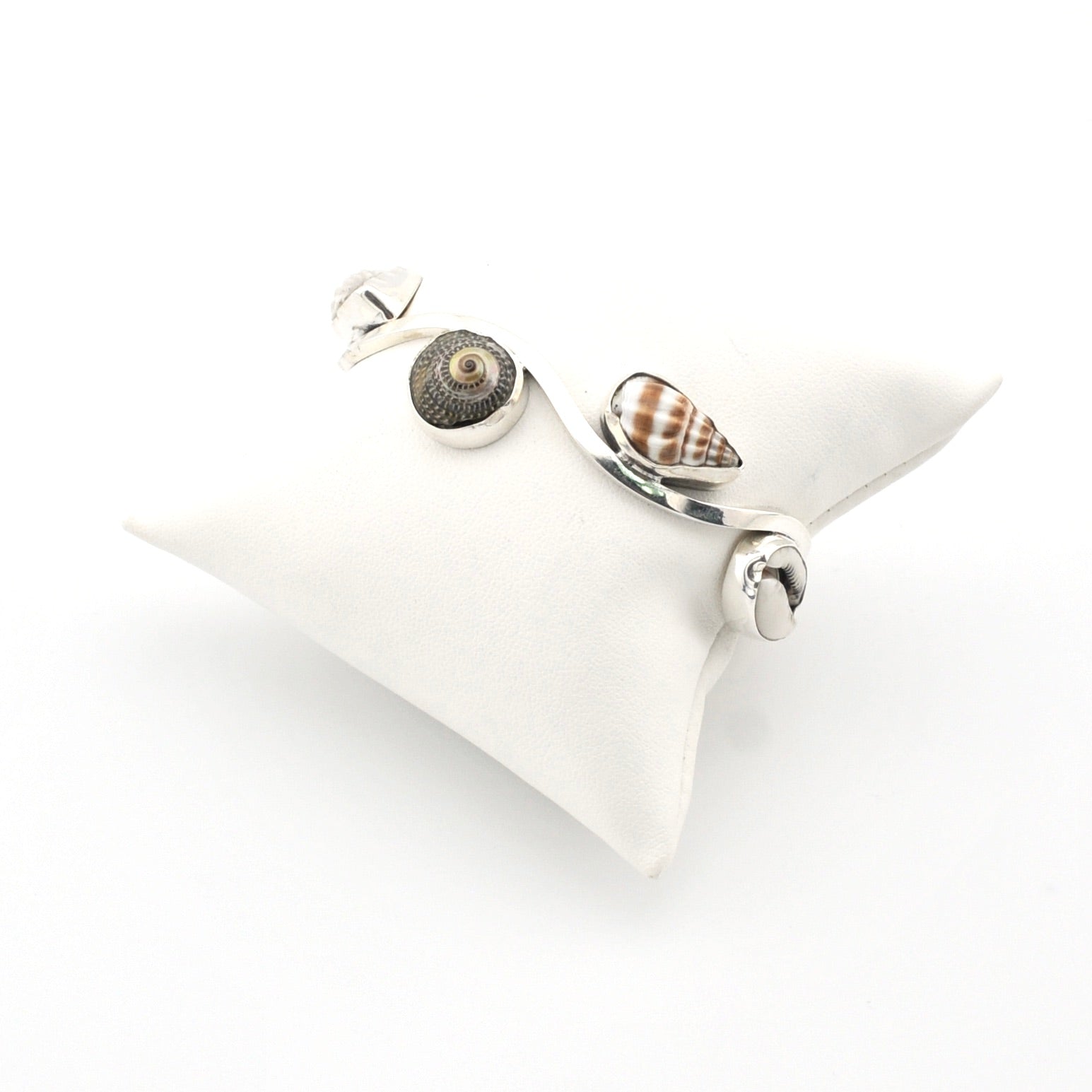 Silver bracelet with shell charms on a white background