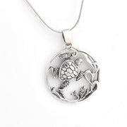 Silver turtle pendant necklace on a white background