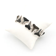 Silver bracelet with shark teeth on a white background