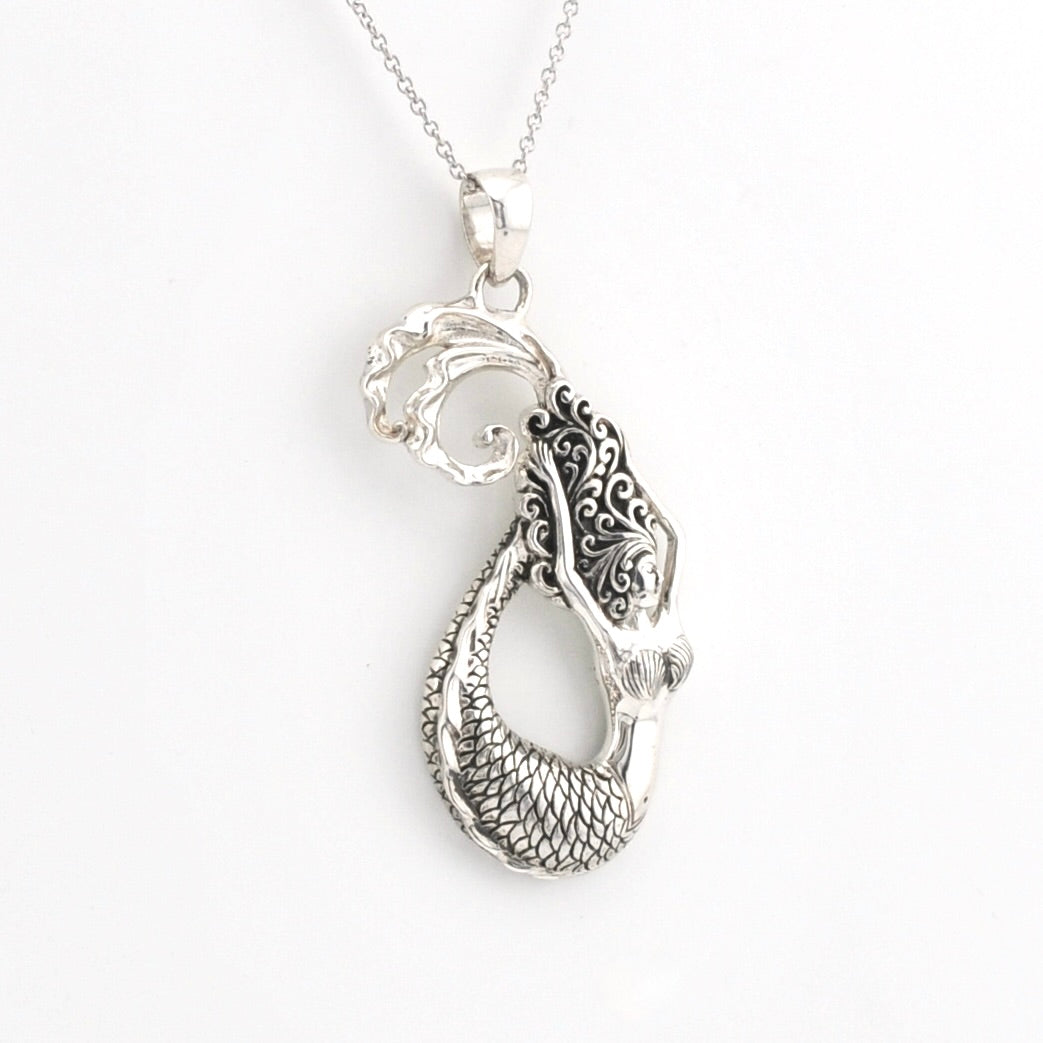 A silver mermaid pendant necklace with detailed scales and hair, shown on a white background.