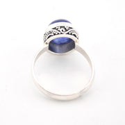 Silver ring with blue stone on a white background