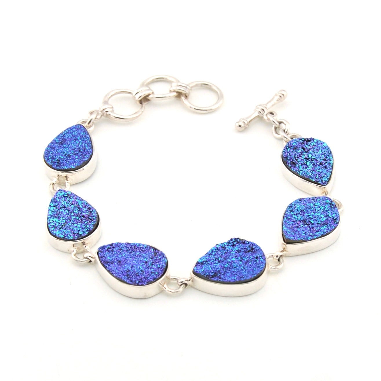 Silver bracelet with blue teardrop-shaped stones on a white background