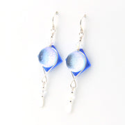 Blue and silver earrings on a white background