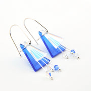 Blue and silver earrings on a white background