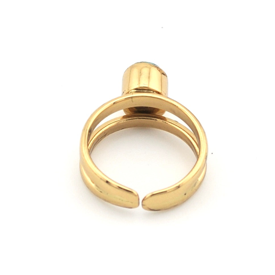 Gold cuff ring on white background