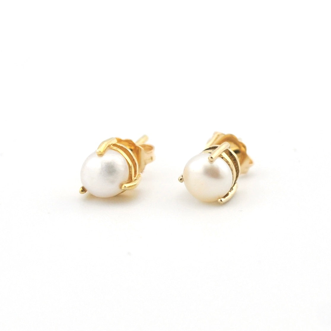 Pair of pearl earrings with gold posts on a white background