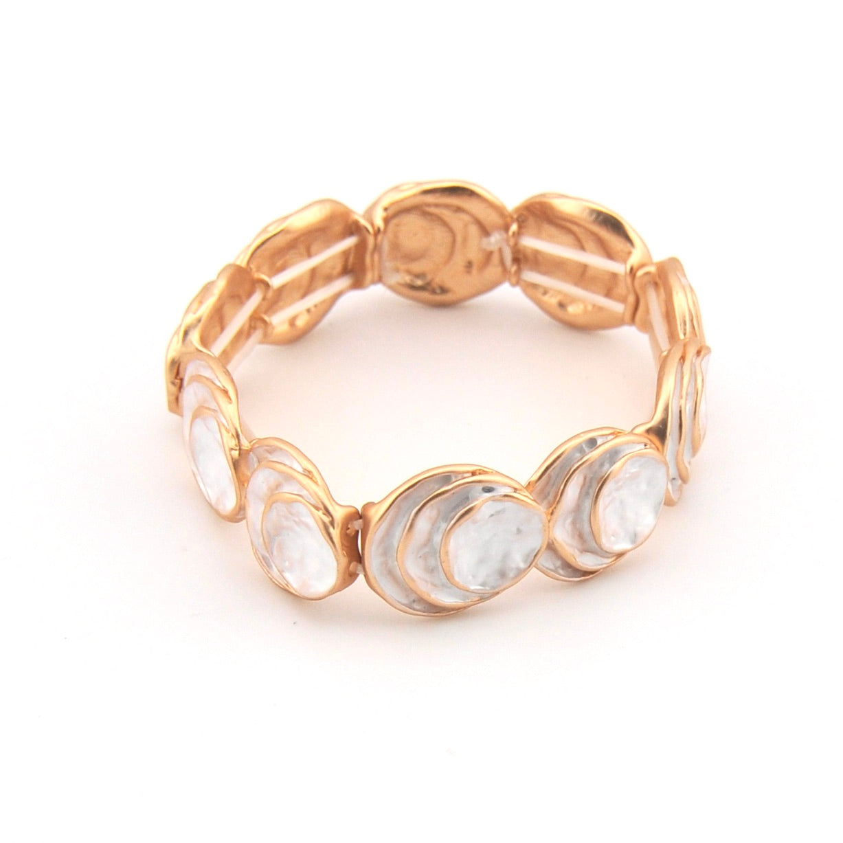 Gold bracelet with circular elements on a white background