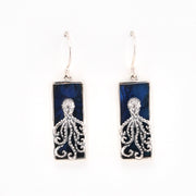 Pair of silver octopus earrings with blue rectangular stones on a white background
