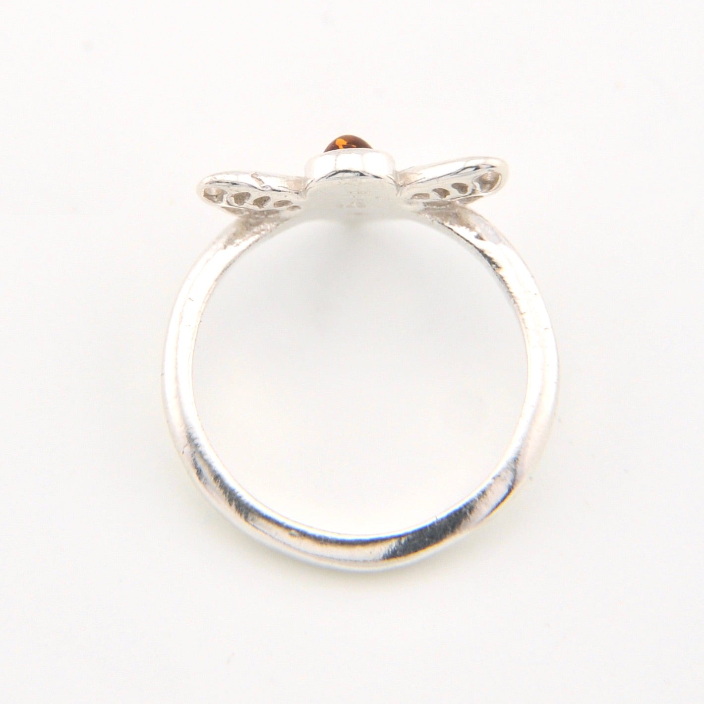 Silver ring with a small gemstone on a white background
