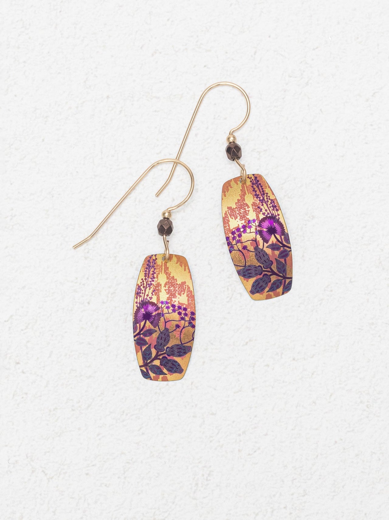 Pair of floral-patterned earrings on a textured white background