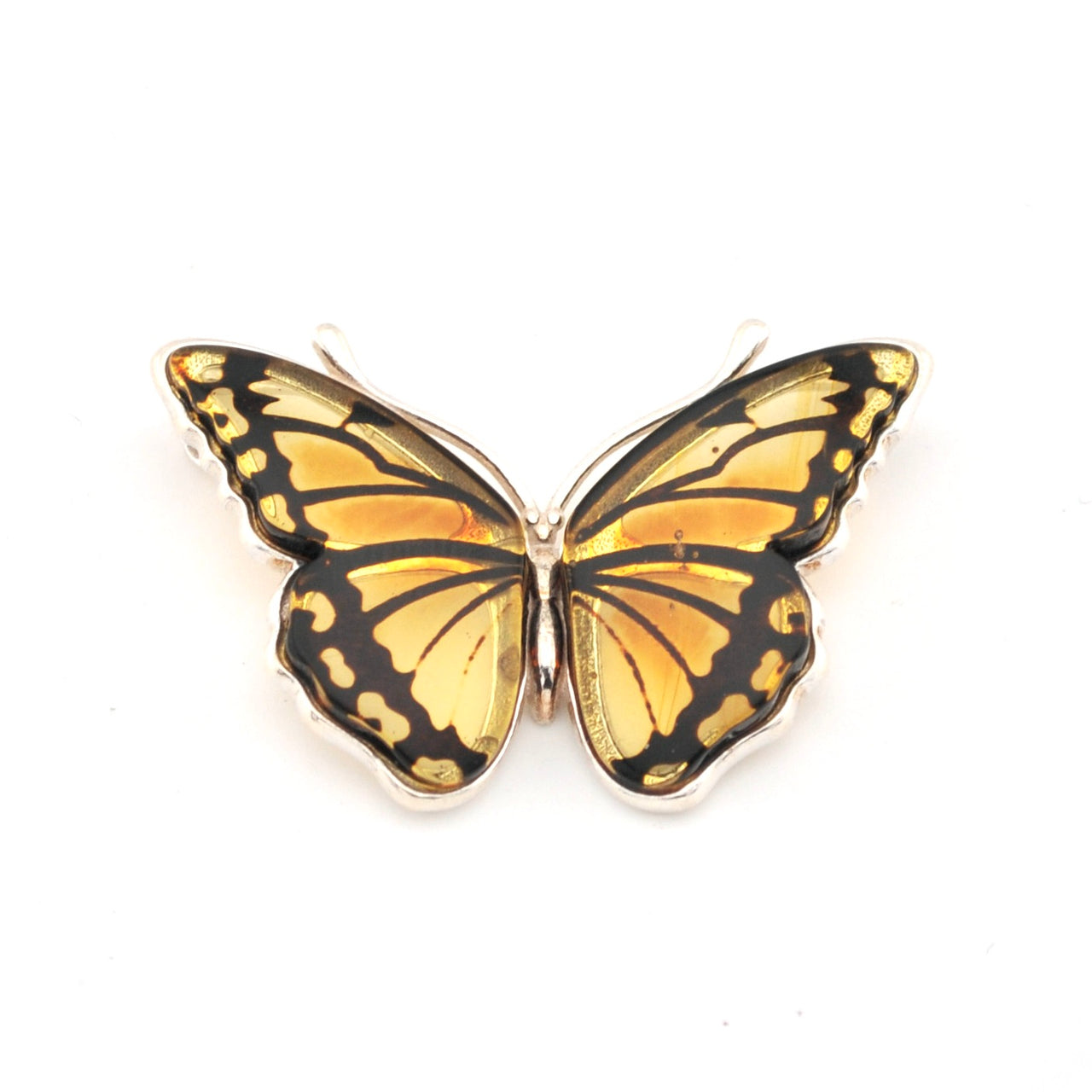 Butterfly-shaped jewelry piece with gold and black design on a white background