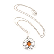 Silver necklace with a circular pendant featuring an orange stone on a white background