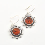 Sunflower earrings with amber-colored stones on a white background