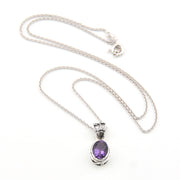 Silver necklace with a purple pendant on a white background